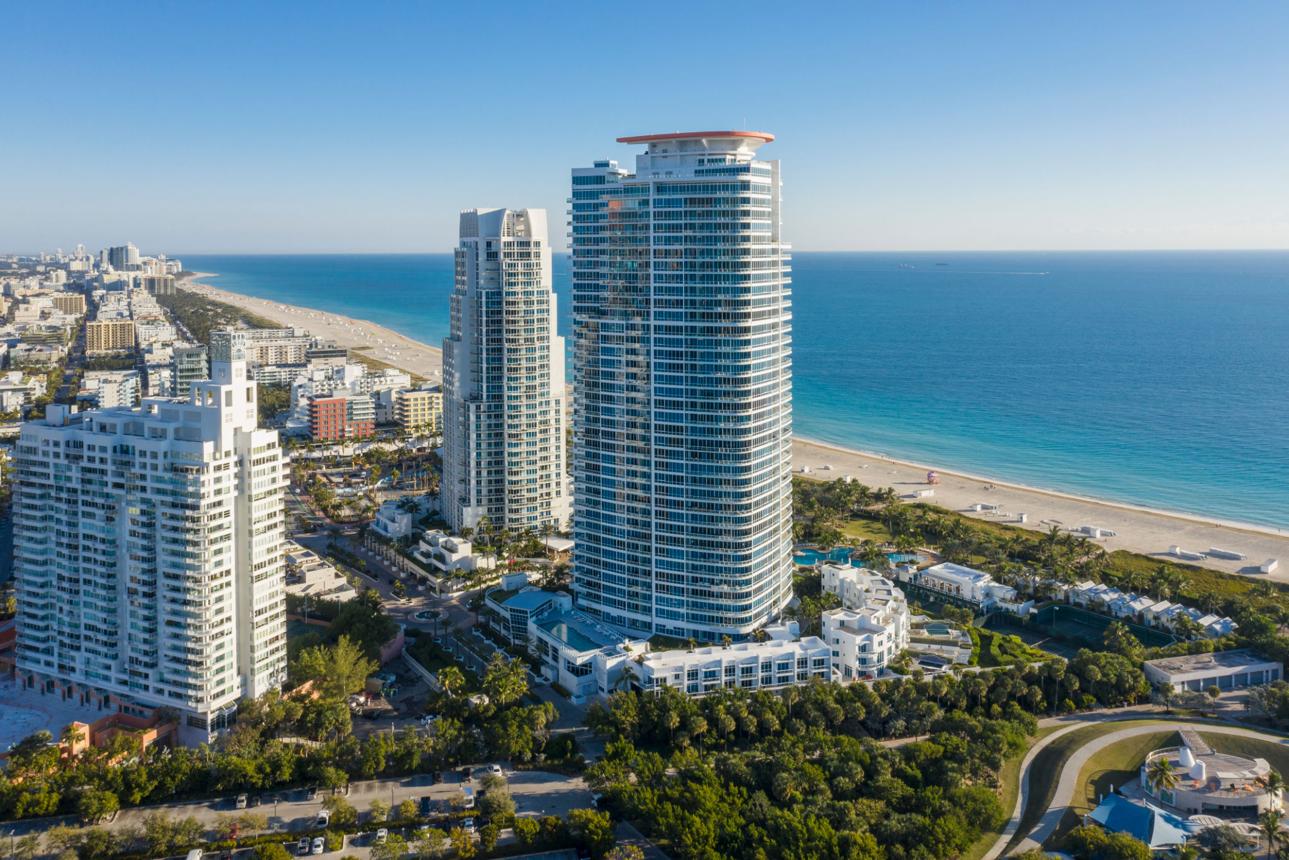 Miami waterfront residence at sunset with infinity pool overlooking the bay